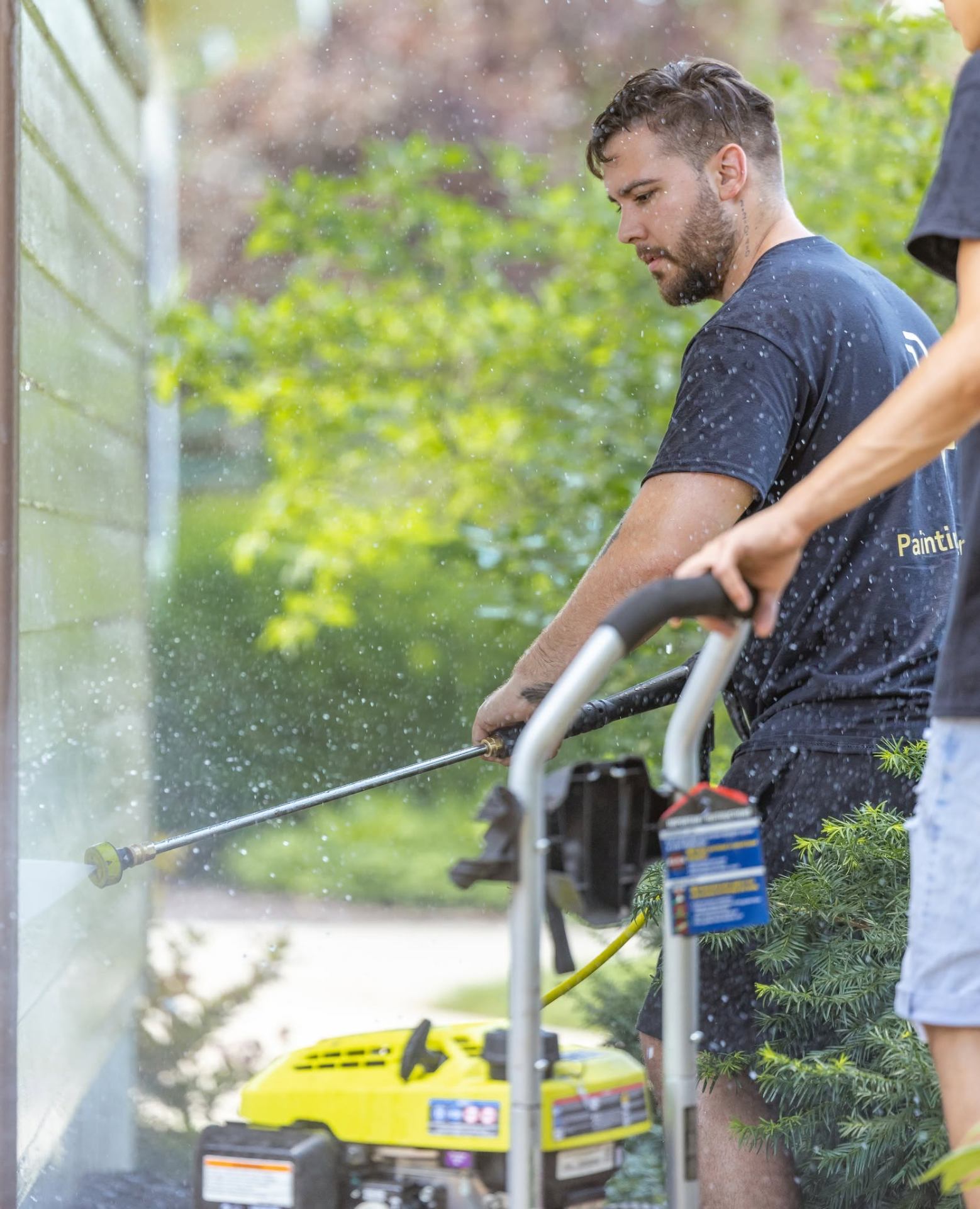 Jose Romero, owner of JR Painting & Contracting LLC, holding a paintbrush