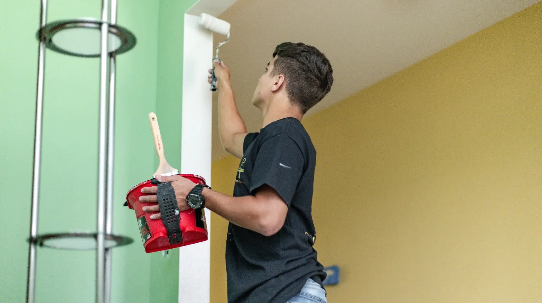 JR Painting team member rolling a fresh coat onto an interior wall